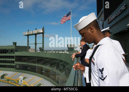 170728-N-CU914-062 GREEN BAY, Wis. (July 28, 2017) – Boatswain’s Mate 3rd Class Jalen Walker, a native of Milwaukee, peers over the railing onto Lambeau Field, home of the Green Bay Packers football team, during Green Bay/Fox Cities Navy Week. Navy Week programs serve as the U.S. Navy's principal outreach effort into areas of the country that lack a significant Navy presence, helping Americans understand that their Navy is deployed around the world, around the clock, ready to defend America at all times. (U.S. Navy photo by Mass Communication Specialist 2nd Class Lenny LaCrosse/Released) Stock Photo