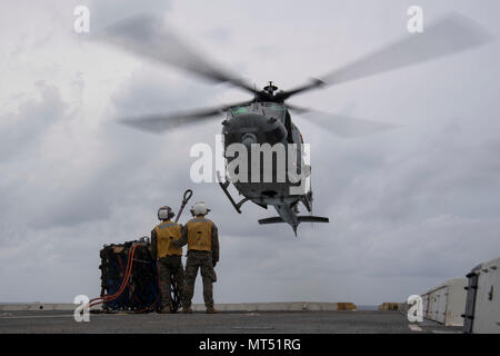 PACIFIC OCEAN (July 31, 2017) Marines assigned to the Marine Medium Tiltrotor Squadron 161 (reinforced) aboard the amphibious transport dock ship USS San Diego (LPD 22), prepare to hook a cargo pendant on a UH-1Y Venom on the ship’s flight deck. San Diego, part of the America Amphibious Ready Group, with embarked 15th Marine Expeditionary Unit, is operating in the Indo-Asia Pacific region to strengthen partnerships and serve as a ready-response force for any type of contingency. (U.S. Navy photo by Mass Communication Specialist 3rd Class Justin A. Schoenberger/Released)