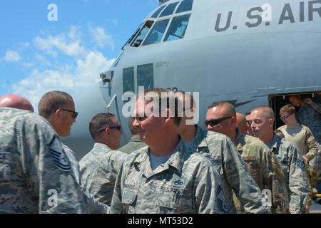 Members of the 103rd Airlift Wing, Air National Guard return to Bradley Air National Guard Base, East Granby, Conn., after serving on a deployment to multiple locations in Southwest Asia, July 4, 2017. Upon their return, the Airmen were greeted by fellow members of the 103rd Airlift Wing, family and friends.  (U.S. Air National Guard Photo by Tech. Sgt. Tamara R. Dabney/released) Stock Photo