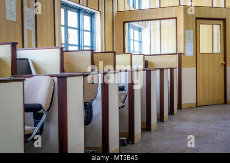 Small individual cabins with computers and chairs in an office Stock Photo