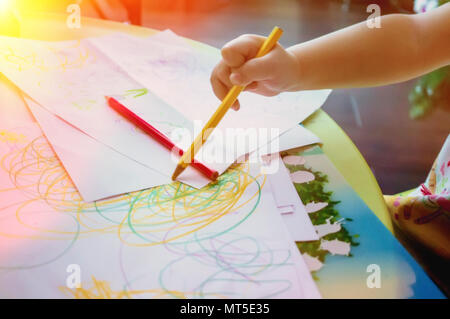 Close-up of a small child draws colored pencils Stock Photo