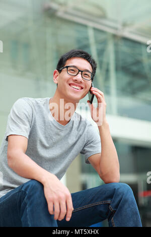one happy confident young Chinese college student in campus Stock Photo