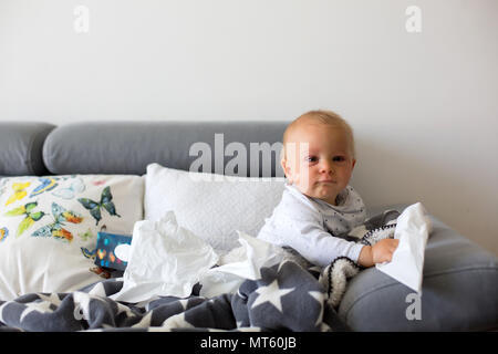 Sick Little Toddler Boy Sitting On A Couch In Living Room