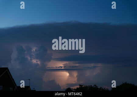 Lightning illuminating the inside of a distant thunder cloud Basingstoke Hampshire England Stock Photo