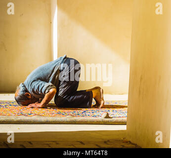 View on old man is praying in mosque in Iran Stock Photo