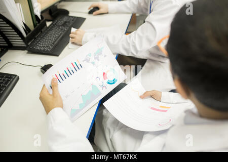 Technicians analyzing charts in factory office Stock Photo