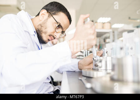 Arabian technician replacing bearing in factory shop Stock Photo