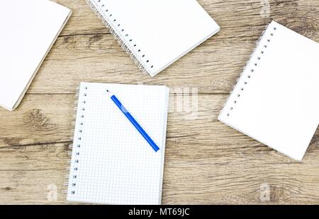 Marker pen and notebook on wooden board Stock Photo