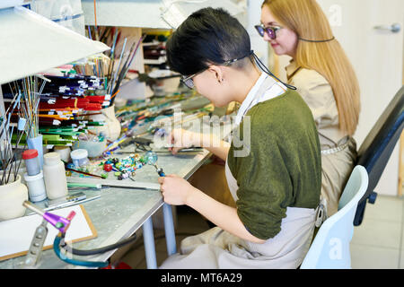 Two Female Artists Working in Glassworking Studio Stock Photo