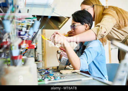 Two Female Artists Collaborating in Glassworking Studio Stock Photo