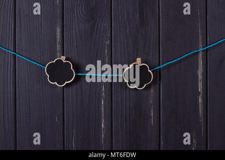 Clothespins with space for text on a black wooden fence Stock Photo