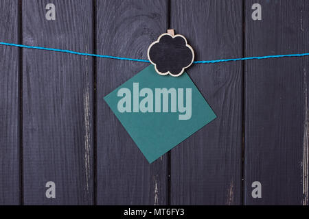Clothespins with space for text on a black wooden fence Stock Photo
