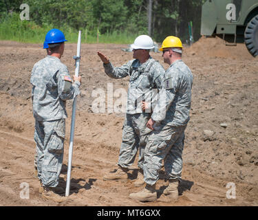 173rd Brigade Engineer Battalion is a Wisconsin Army National Guard engineering unit that provides combat engineer and construction capabilities. An archival image documents soldiers reviewing surveying results on July 19 during horizontal construction work at the Mosinee Athletic Complex as part of annual training with the 229th Engineer Company. Stock Photo