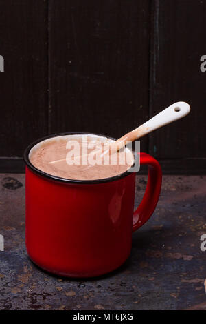 Hot chocolate in red mug on grunge background Stock Photo