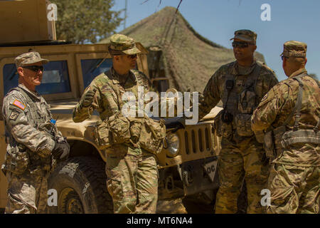 Maj. Gen. Todd McCaffrey, commanding general of First Army Division East, second from the right, discusses an attack that occurred as a part of Combat Support Training Exercise 91-17-03 July 20, 2017 on Fort Hunter Liggett, CA. CSTX is a 91st Training Division led exercise designed to assist combat-service and combat-service-support units in planning, preparing, supervising and executing of pre-mobilization collective training. (U.S. Army photo by Sgt. Rakeem Carter) Stock Photo