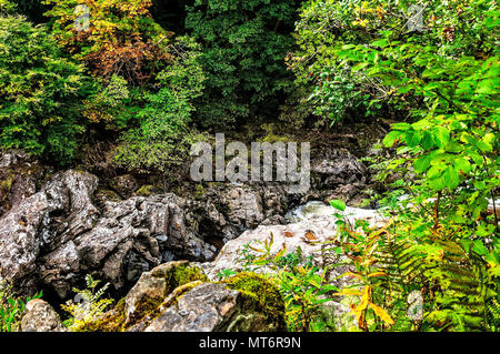 Slabs of angular igneous looking rocks lie at angles one on another at ...