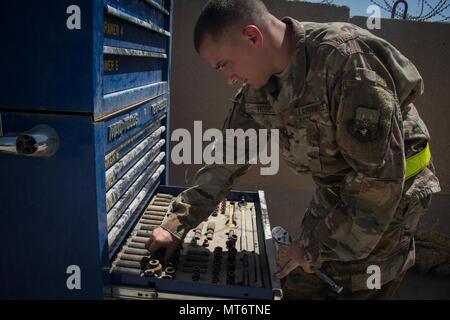U.S. Air Force Master Sgt. Daniel Hose, the NCOIC of vehicle maintenance assigned to the 442nd Air Expeditionary Squadron, retrieves tools from a tool box at Baghdad Diplomatic Support Center, Iraq, June 5, 2017. Daniel and his brother Master Sgt. Scott Hose are both deployed to Iraq in support of Combined Joint Task Force -Operation Inherent Resolve. CJTF-OIR is the global Coalition to defeat ISIS in Iraq and Syria. (U.S. Air Force photo by Tech. Sgt. Jonathan Hehnly) Stock Photo