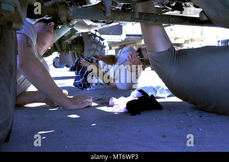 1st Battalion, 141st Brigade Support Battalion is part of the 41st Infantry Brigade Combat Team in the Oregon Army National Guard. On July 25, 2017, mechanics from Company H inspected a truck with an automatic transmission fluid leak during annual training at Camp Umatilla, Oregon. The archival image documents maintenance personnel diagnosing the vehicle issue in the field. Stock Photo