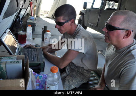 41st Infantry Brigade Combat Team is a United States Army National Guard brigade headquartered in Oregon. The archival image documents mechanics of Company H, 1st Battalion, 141st Brigade Support Battalion inspecting parts to repair an automatic transmission fluid leak on a military truck during annual training at Camp Umatilla on July 25, 2017. Stock Photo