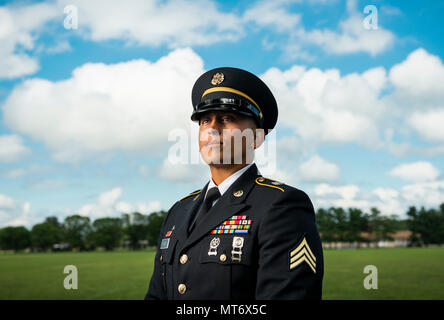 Sgt. Andrew Paredes, a U.S. Army Reserve wheeled vehicle mechanic Soldier with the 841st Engineer Battalion, of North Miami Beach, Florida, participates in a promotional photo shoot for Army Reserve recruiting at Joint Base McGuire-Dix-Lakehurst, New Jersey, July 25, 2017. (U.S. Army Reserve photo by Master Sgt. Michel Sauret) Stock Photo