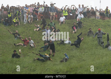 Competitors take part in the annual cheese rolling competition at Cooper's Hill in Brockworth, Gloucestershire. Stock Photo