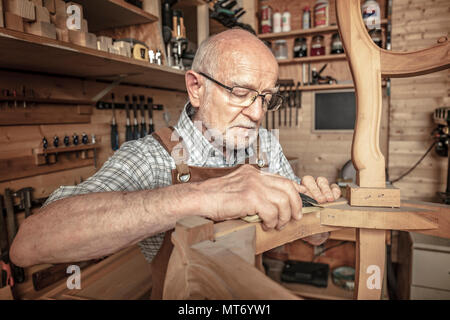 senior carpenter work in his workshop Stock Photo