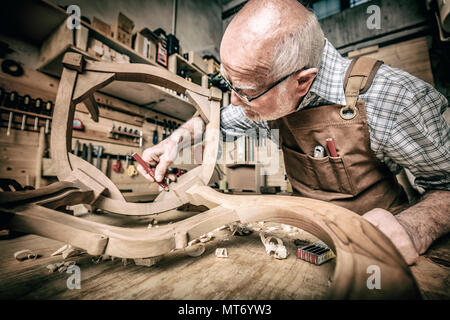 old woodworker at work in workshop Stock Photo