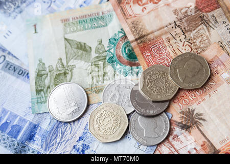 Jordanian dinars banknotes and piastres coins, close-up background photo Stock Photo