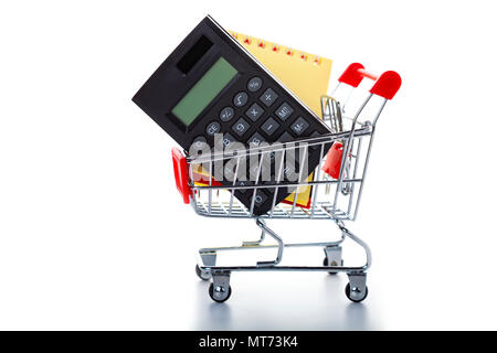 Shopping cart with a notebook and a calculator isolated on a white background. Stock Photo