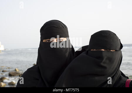 Two Saudi women posing near the Red Sea in Jeddah, Saudi Arabia during Ramadan Stock Photo