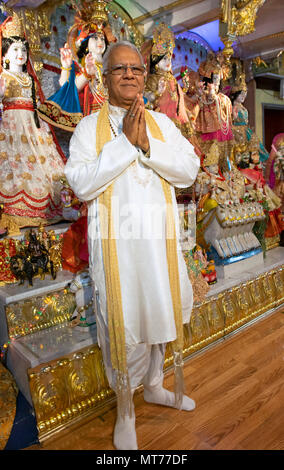 Posed portrait of a Hindu priest - or Brahmin  - at the Shri Lakshmi Narayan Mandir  temple in Richmond Hill, Queens, New York. Stock Photo