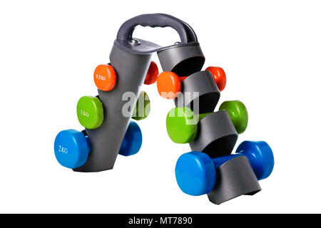 Set of colored isolated dumbbells for sport on a white background folded on a special black stand. Stock Photo