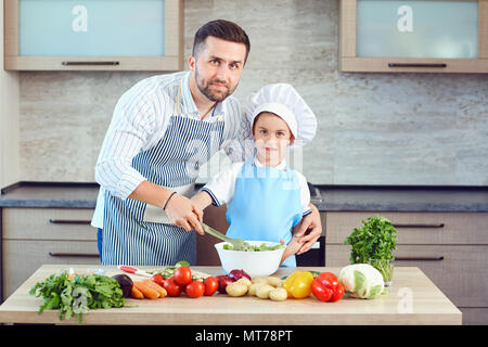 Father and son are cooking in the kitchen Stock Photo