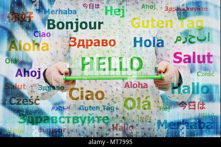 Young woman holding electronic tablet showing the word hello in different languages. Learning and speaking many languages easier using modern technolo