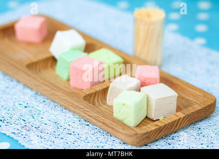 A lot of sweet colorful marshmallows on wooden plate Stock Photo