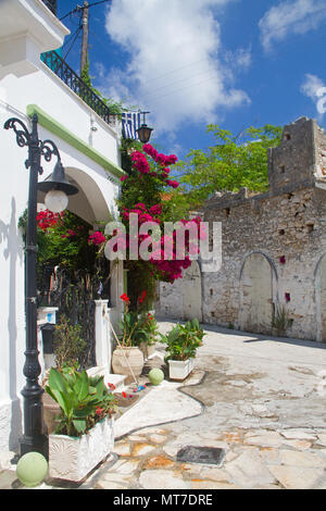 Pink Bougainvillea, climbing the white wall of a Mediterranean house in Fiskardo on the Greek island Cephalonia Stock Photo