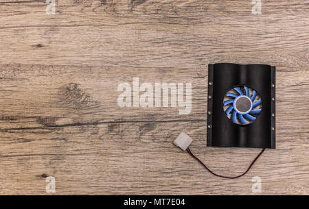 hard disk cooler with blue fan on wooden background Stock Photo