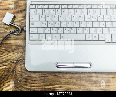 Open padlock on network cables on a laptop. Stock Photo