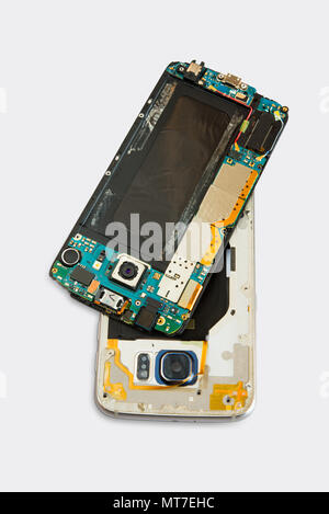 Broken cell phone  with small screwdriver on white background Stock Photo