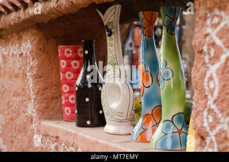 Multicoloured/Multicolored ceramic vases with floral designs on display for sale at Shilparamam arts and crafts village in Hyderabad, India. Stock Photo