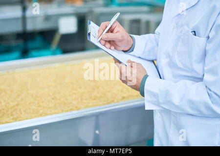Factory Inspector Taking Notes Stock Photo