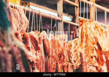 Butcher selling pork in Hong Kong market. Stock Photo