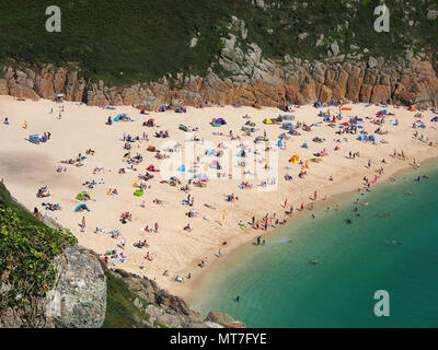 Beach at Pothcurno Bay / Cove in Cornwall, England, UK, showing the beach on a summer day. Aerial shot of holidaymakers sunbathing and swimming. Stock Photo