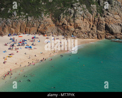 Beach at Pothcurno Bay / Cove in Cornwall, England, UK, showing the beach on a summer day. Aerial shot of holidaymakers sunbathing and swimming. Stock Photo