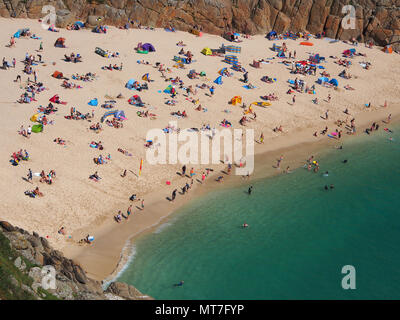 Beach at Pothcurno Bay / Cove in Cornwall, England, UK, showing the beach on a summer day. Aerial shot of holidaymakers sunbathing and swimming. Stock Photo