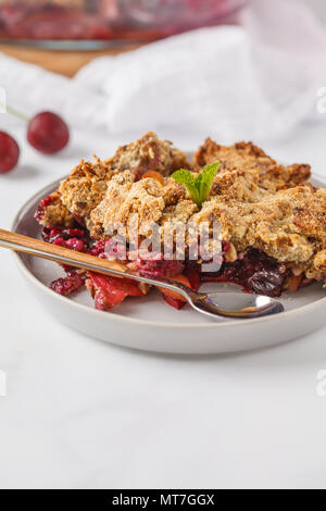 Summer berry crumble pie, white background, vegetarian breakfast. Healthy vegan food concept.