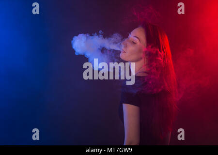 young woman smoking electronic cigarette Stock Photo