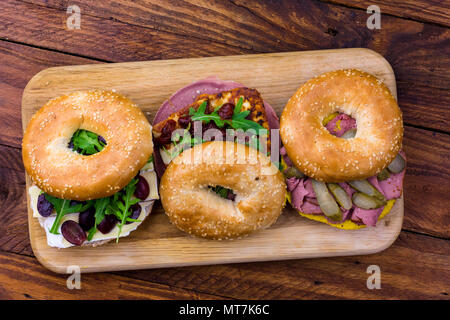 Three bagels with different fillings Stock Photo