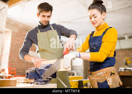 Modern Carpenters Cutting Wood Stock Photo