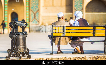 View on two old man sitting on bench in Yazd - Iran Stock Photo